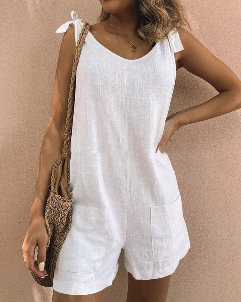 Sleeveless white pocket shorts jumpsuit with bow shoulder ties and front pockets