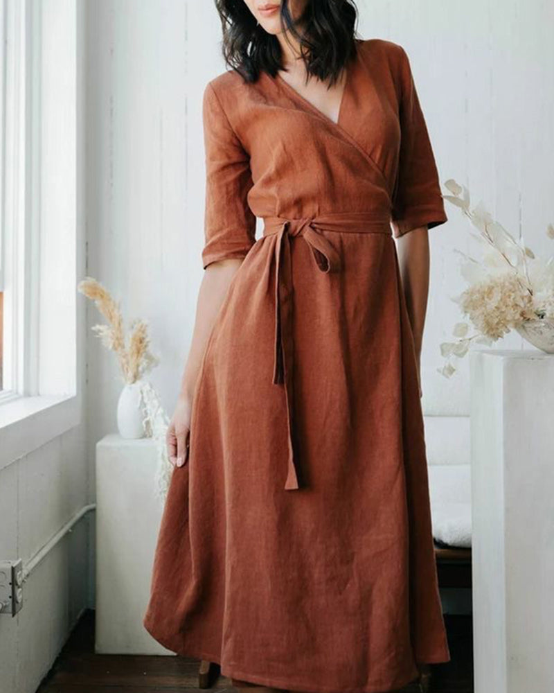 Caramel wrap dress with V-neck, tie waist, 3/4 sleeves.