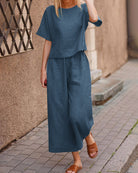 Navy blue two-piece set with loose T-shirt and wide-leg cropped pants