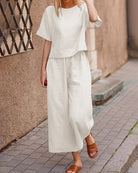 Loose fit two piece set: white short-sleeve top and wide-leg cropped pants