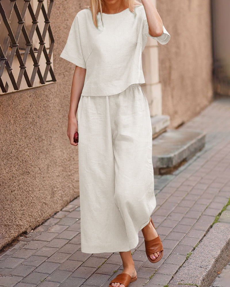 Loose fit two piece set: white short-sleeve top and wide-leg cropped pants