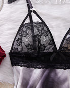 Black lace babydoll bust detail with bow at center and scalloped lace trim