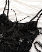 Black sheer lace bodysuit with underwire cups, lace-up front, and adjustable straps