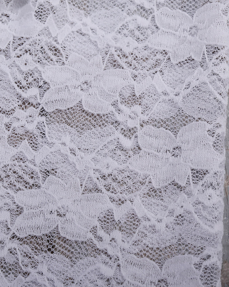 White sheer lace fabric with dense floral pattern texture