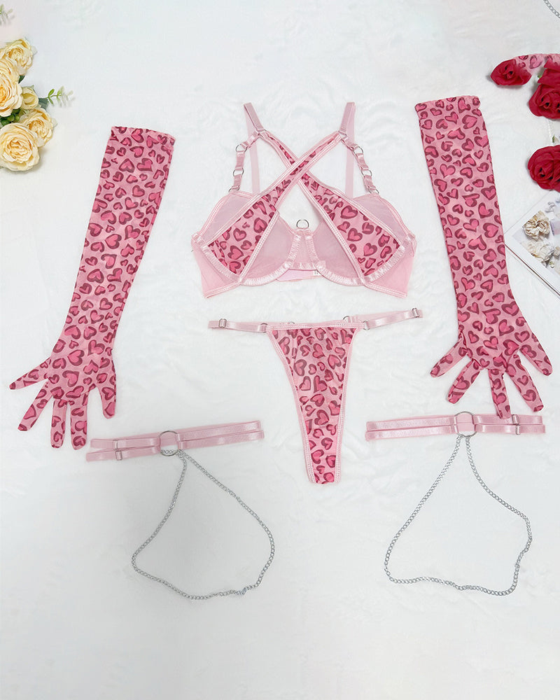 Pink heart-print lingerie set items: bra, thong, garter straps, and glove sleeves