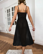 Black lace side-slit dress with open back, mesh skirt, and thin tie straps