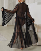 Black sheer belted nightgown, back view, with long flared sleeves and tiered hem