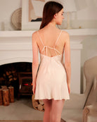 Cream satin slip dress with crisscross spaghetti back straps and lace hem