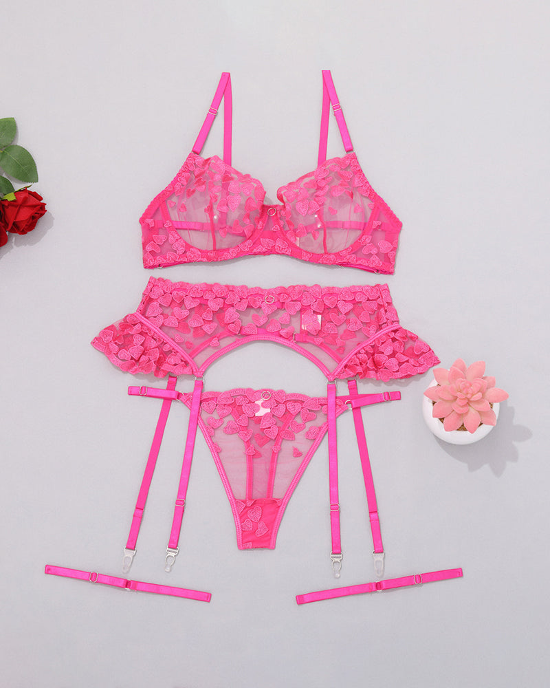 Rose red lace lingerie set flat lay: underwire bra, garter belt, thong, straps