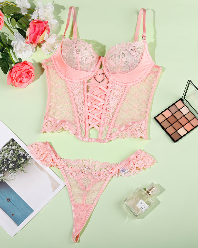 Pink lace corset and thong set, flat lay of bra and brief pieces