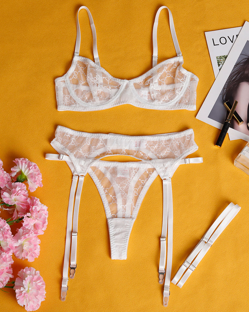 White sheer lace lingerie set: underwire bra, thong, and matching garter belt straps.