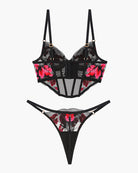 Black floral embroidered corset bra with sheer panels and matching thong set