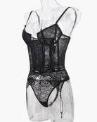 Black lace corset bra and panty set with push-up cups and hanging garter straps, angled