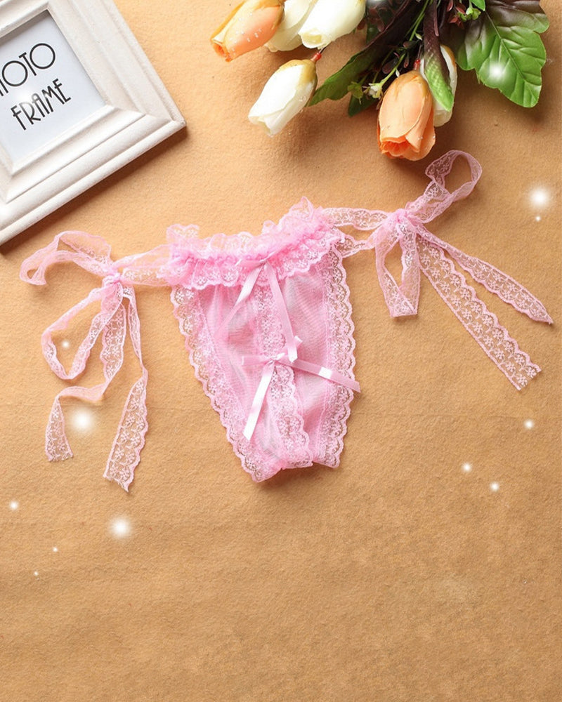 Pink lace crotchless thong with lace-up straps and bow at front.
