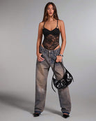 Black sheer floral lace bodysuit with narrow straps and high-cut lace legs