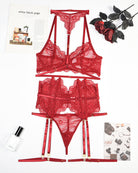 Deep red lace bra, panty, and garter belt set laid flat with matching garters