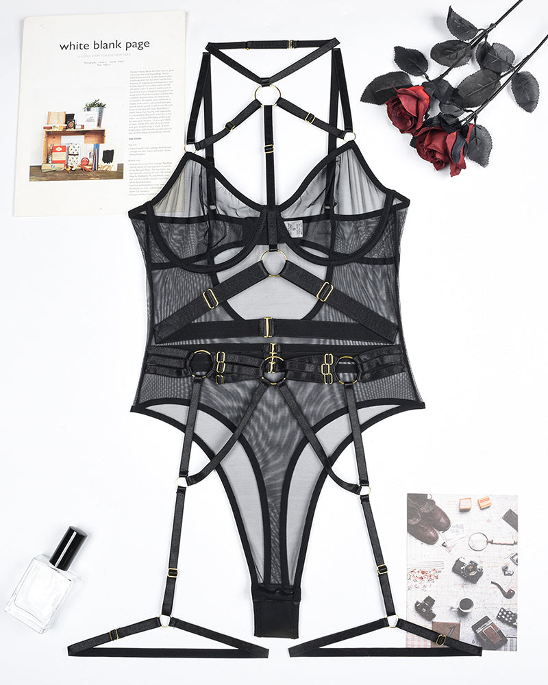 Black mesh bodysuit set with strappy harness and steel ring hardware (flat lay)