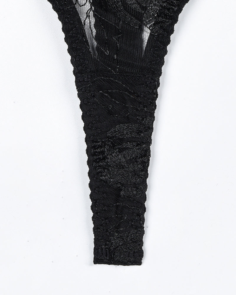 Black lace thigh garter stocking with textured floral pattern and sheer sections