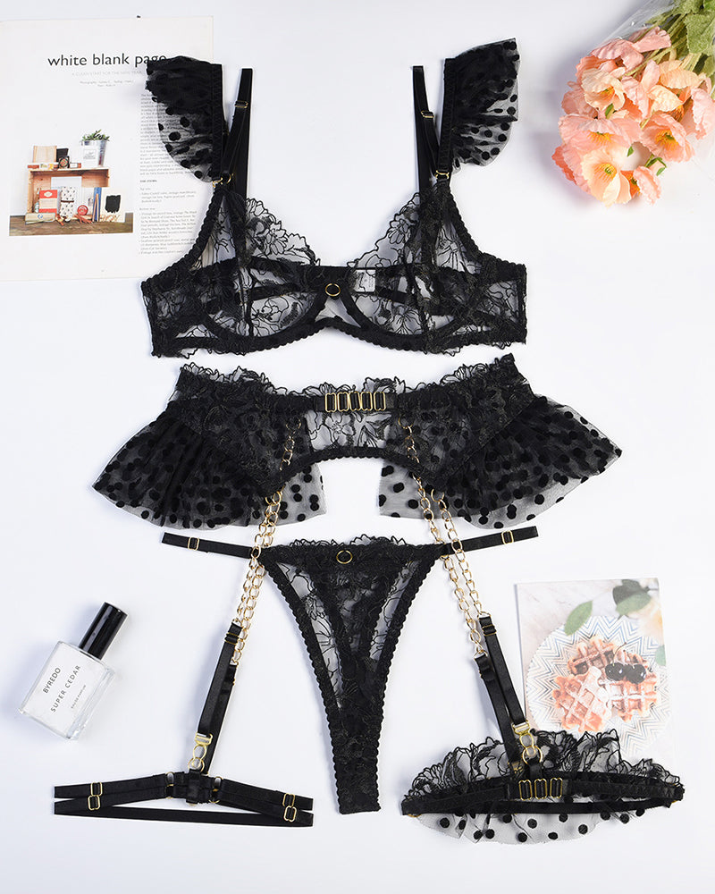 Black embroidered lace lingerie set components with bra, thong, garters, and chain details