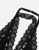 Black lace halter crop top with scalloped trim and circular motif neckline