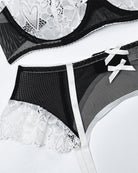 Garter belt with lace trim, bow detail, and black mesh waistband with suspender ties