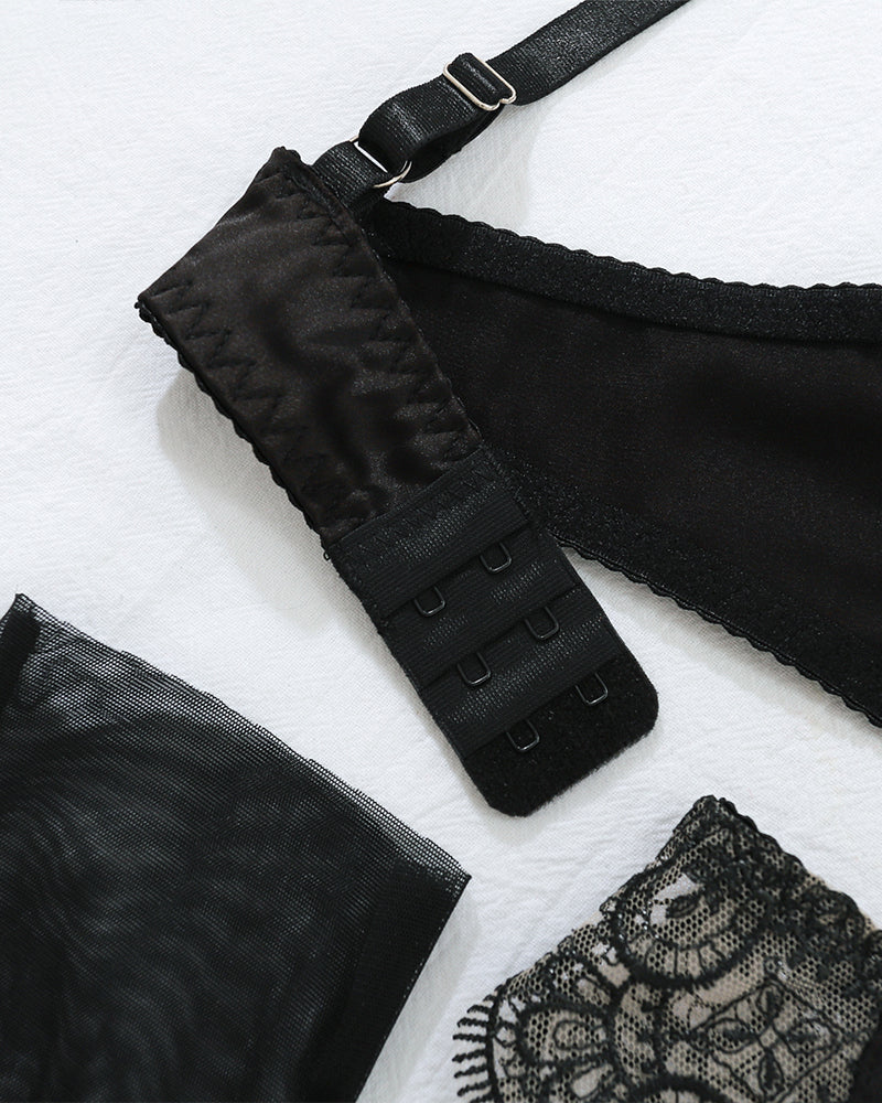 Black adjustable bra strap hooks and lace garter belt fabric detail