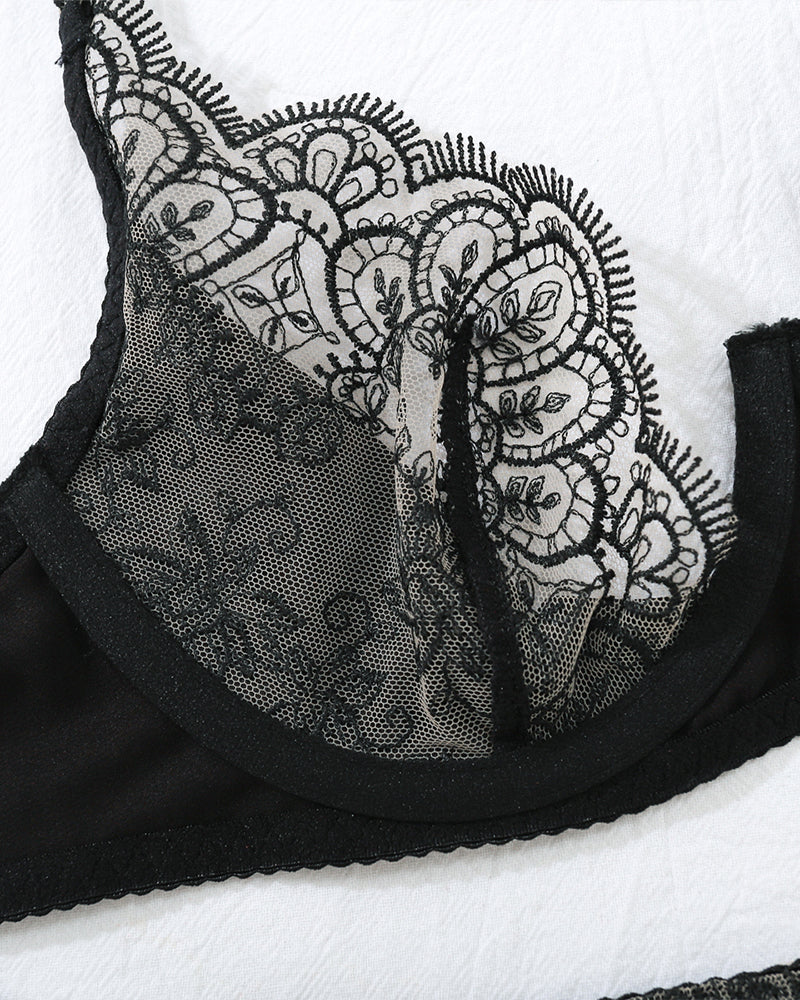 Black lace underwire bra cup with embroidered floral trim and scalloped edge