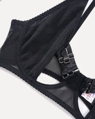 Black mesh glove close-up with elastic bands and metal buckle detail