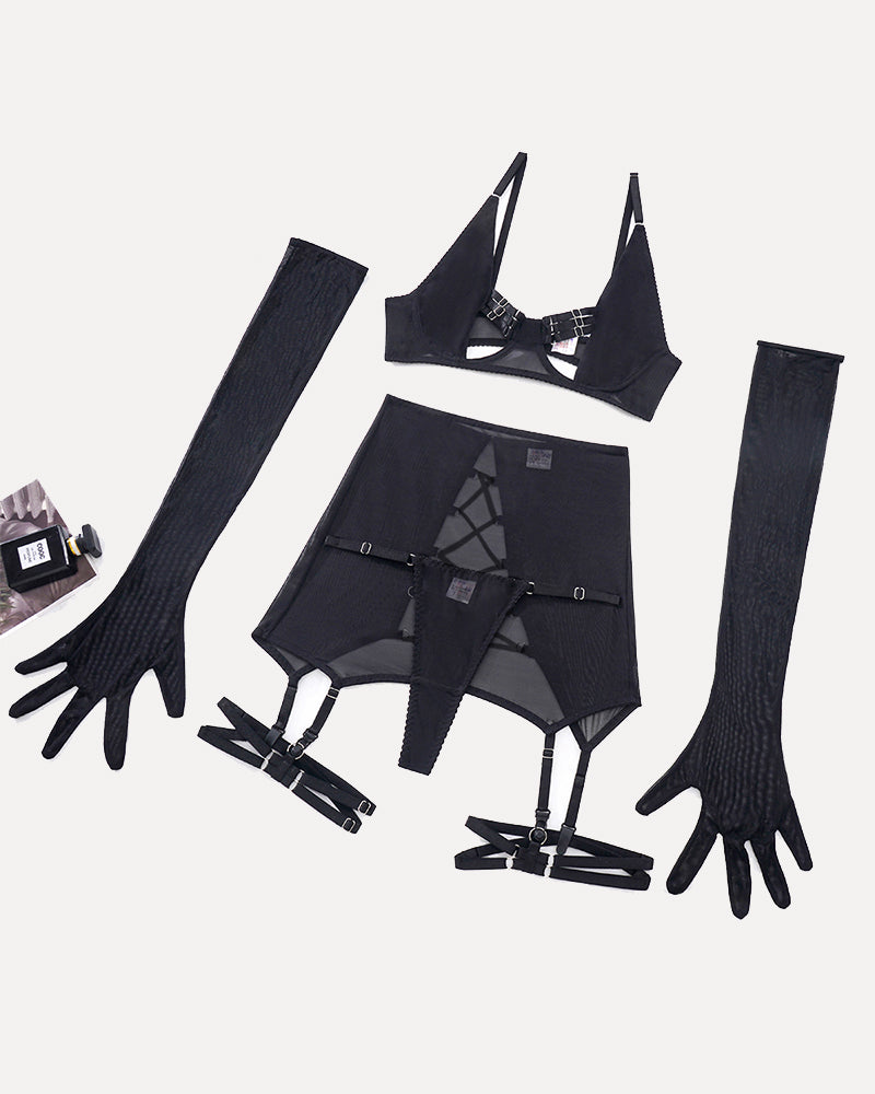 Black lingerie pieces flat lay: bra, mini skirt, garters, and long mesh gloves