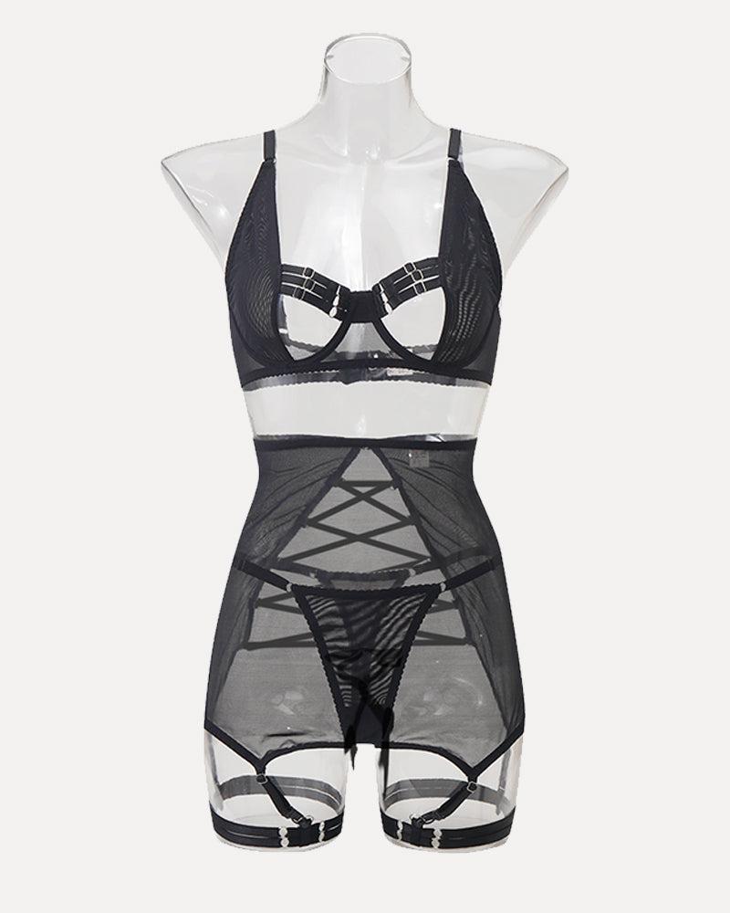 Black mesh lingerie set on mannequin with harness-style straps and garter belt