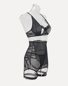 Black mesh lingerie mini dress on mannequin with strappy bra and garter belt
