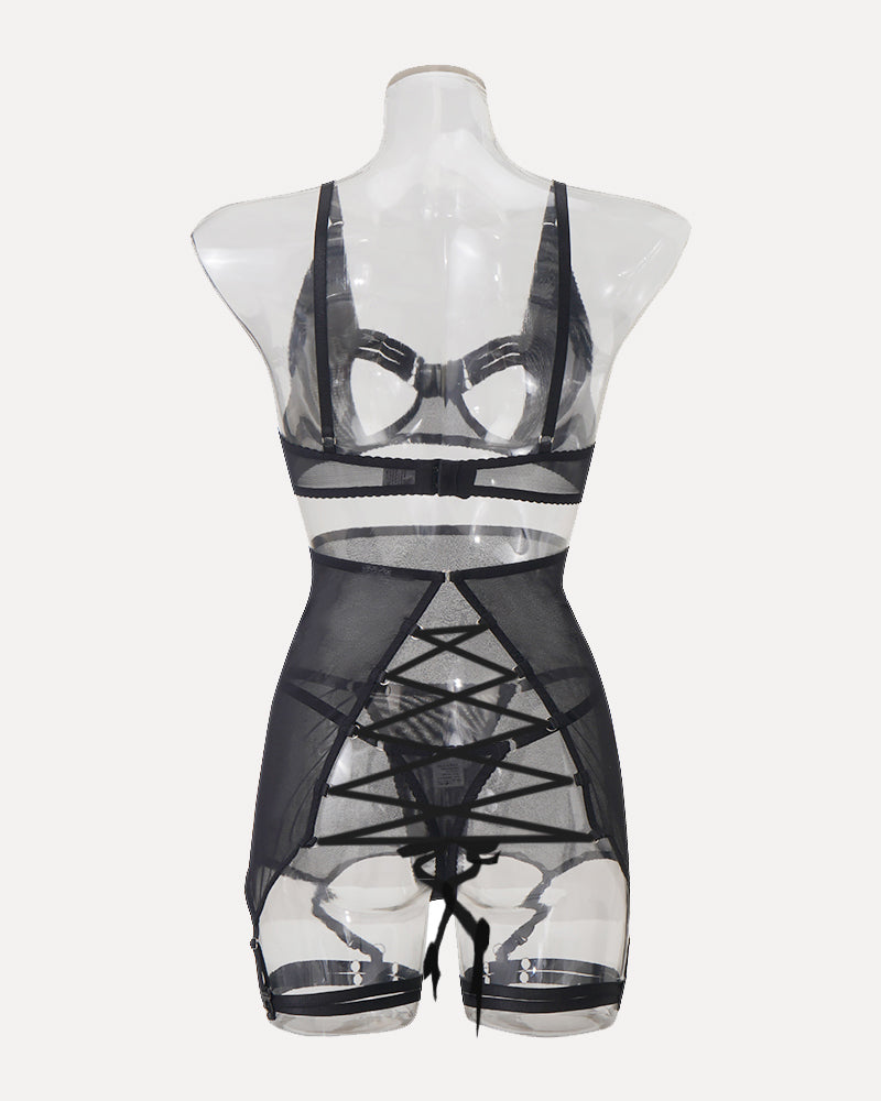 Black mesh lingerie on mannequin with strappy cutouts and garter straps
