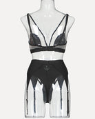 Black mesh lingerie set on mannequin with triangle bra and high-waist garter briefs
