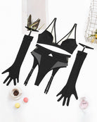 Black mesh lingerie set flat lay with bra, garter belt, thigh straps, and gloves