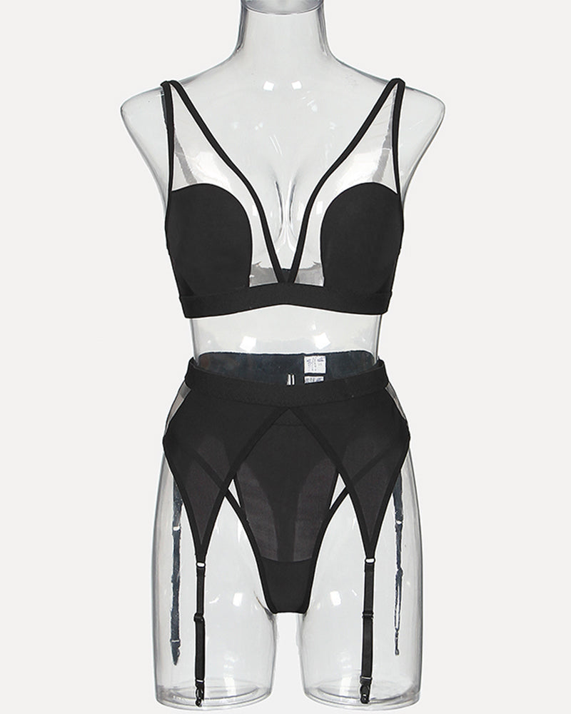 Black mesh lingerie set on mannequin with triangle bra and garter belt suspenders