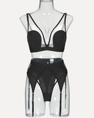 Black mesh lingerie set on mannequin with triangle bra and garter belt suspenders