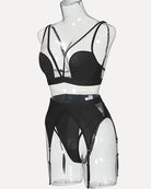 Black mesh lingerie set on mannequin with bra and high-cut garter briefs