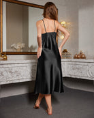 Black satin nightdress with lace back panel, spaghetti straps, back view.
