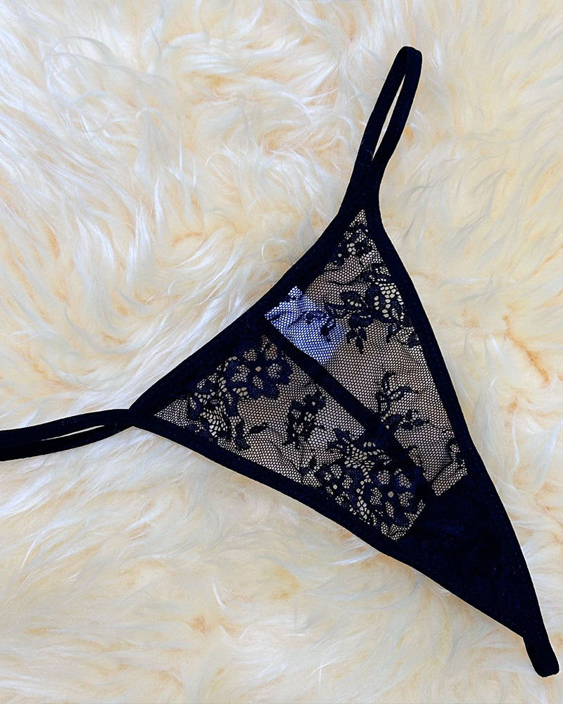 Black lace thong with mesh panel, floral embroidery, and thin adjustable straps