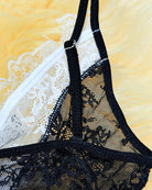 Sheer black lace garter with white lace trim and adjustable strap