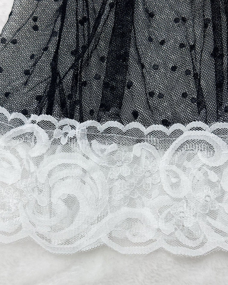 Sheer black tulle with white floral lace trim, scalloped ruffle hem detail