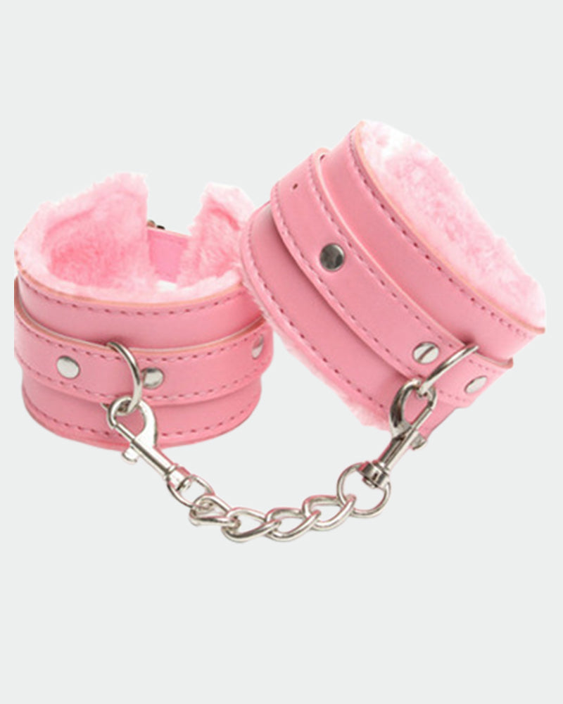 Pink leather plush wrist cuffs with silver chain links and round metal snap studs