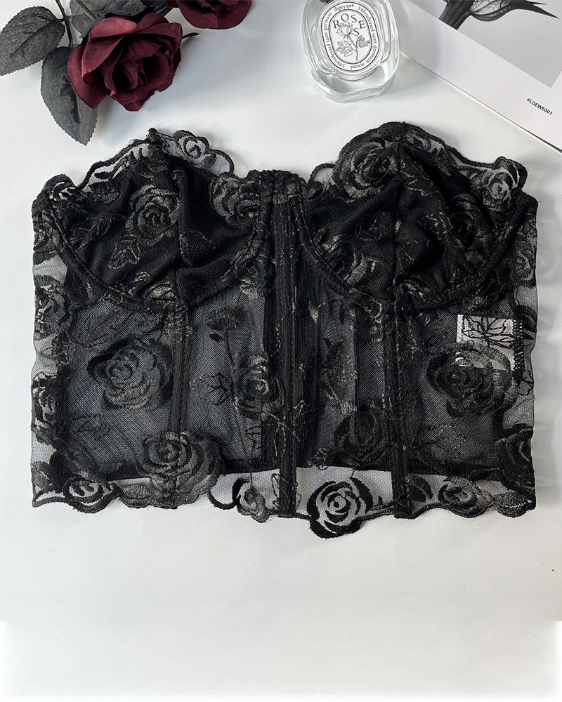 Black strapless mesh corset top flat lay with floral embroidery and boning seams