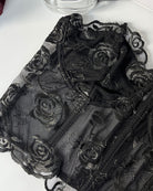 Black strapless mesh corset close-up with floral rose embroidery detail