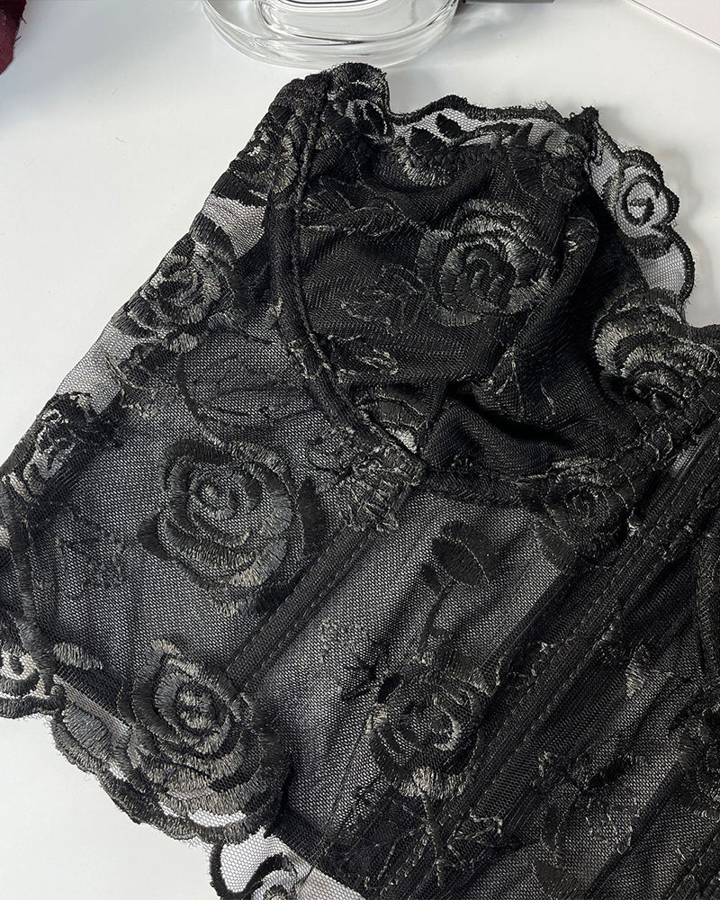 Black strapless mesh corset close-up with floral rose embroidery detail