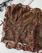 Dark brown floral embroidered mesh bustier close-up with scalloped lace edge and boned seams