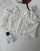 White floral strapless boned mesh bustier laid flat, showing back seams