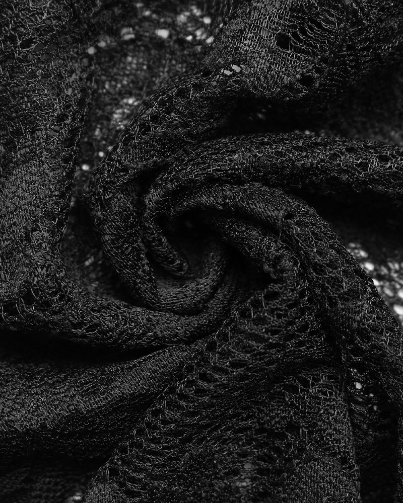Black floral lace fabric closeup with swirl-like embroidery texture