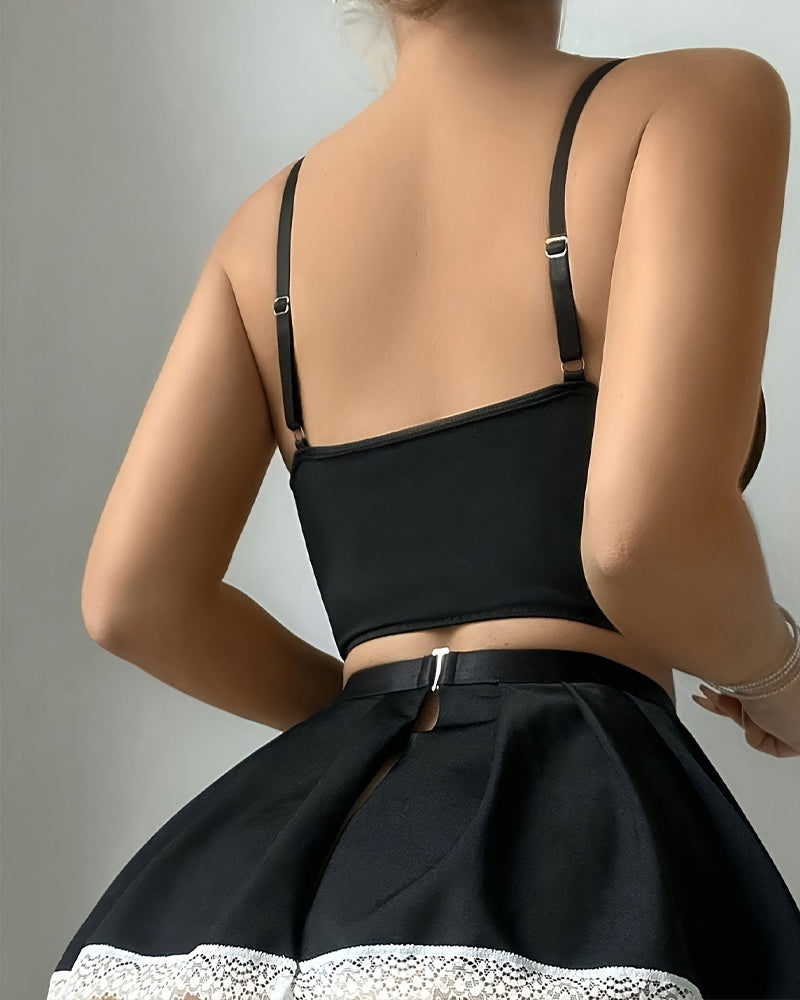 Black backless corset top with adjustable straps and gathered black mini skirt