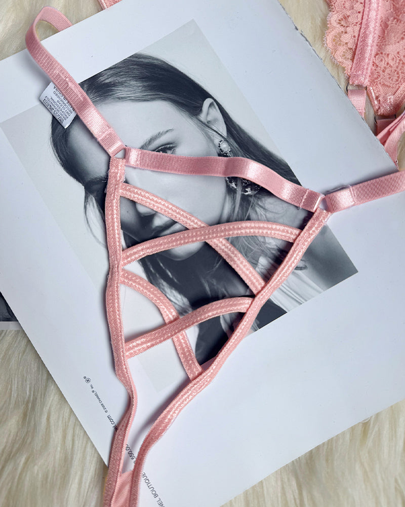 Pink lace lingerie garter straps and corset pieces on product card, close-up